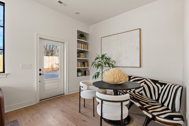 a table with a vase and flowers on it