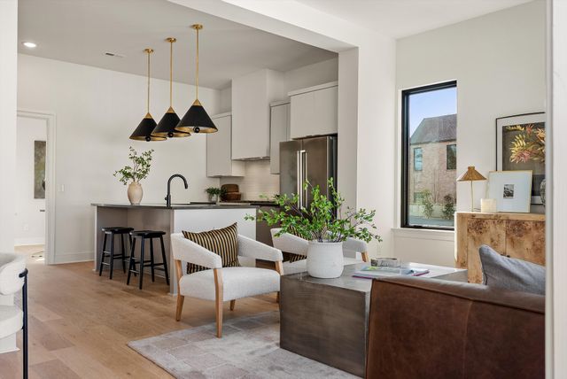a living room with furniture fireplace and a large window