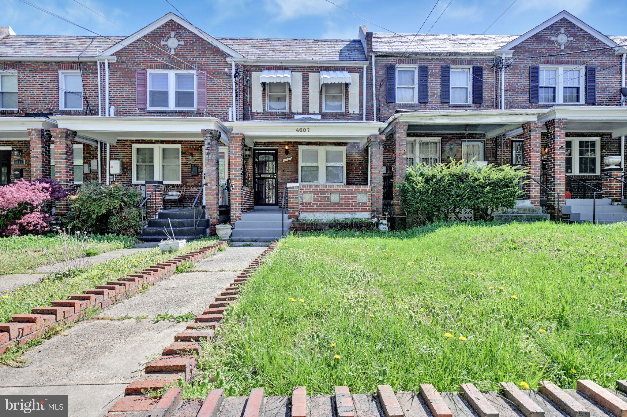 a front view of a residential apartment building with a yard