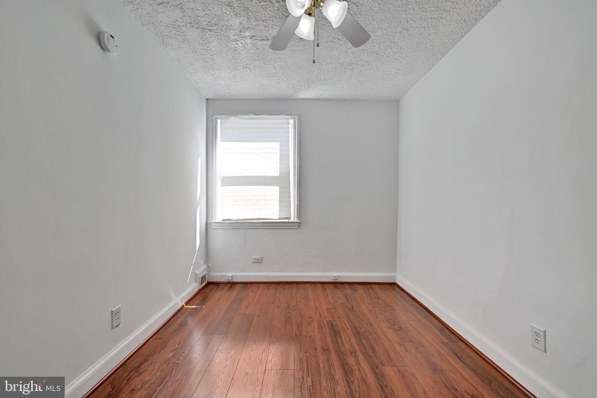 4607 North Capitol Street Northeast Washington, DC 20011 - Photo 14 of 25 wooden floor in an empty room with a window
