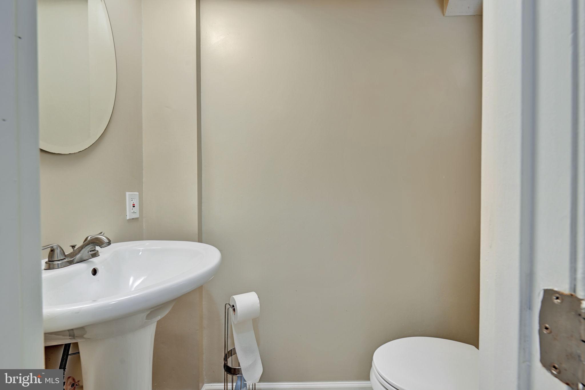 4607 North Capitol Street Northeast Washington, DC 20011 - Photo 19 of 25 a bathroom with a sink a toilet and a mirror