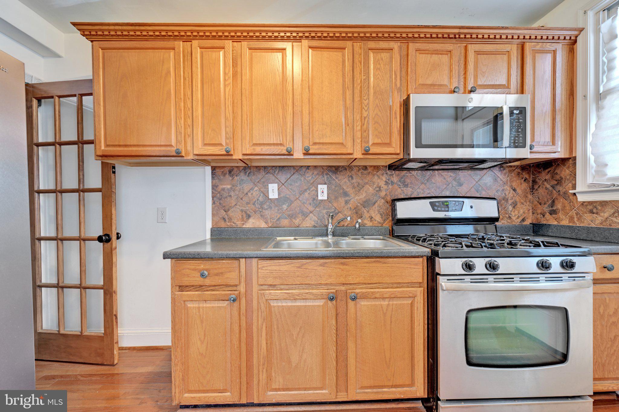 4607 North Capitol Street Northeast Washington, DC 20011 - Photo 8 of 25 a kitchen with granite countertop a stove top oven