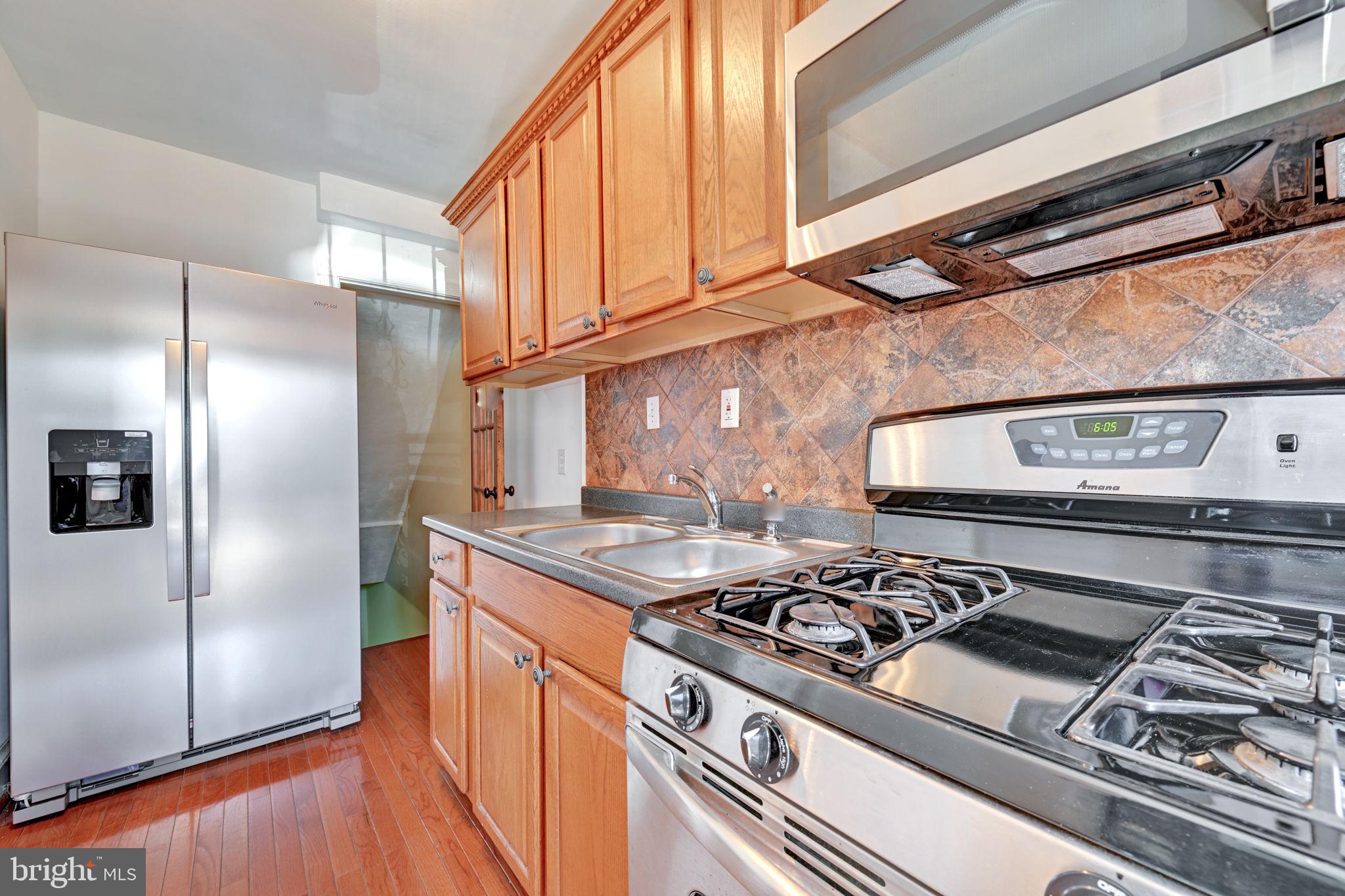 4607 North Capitol Street Northeast Washington, DC 20011 - Photo 9 of 25 a kitchen with stainless steel appliances granite countertop a stove and a refrigerator