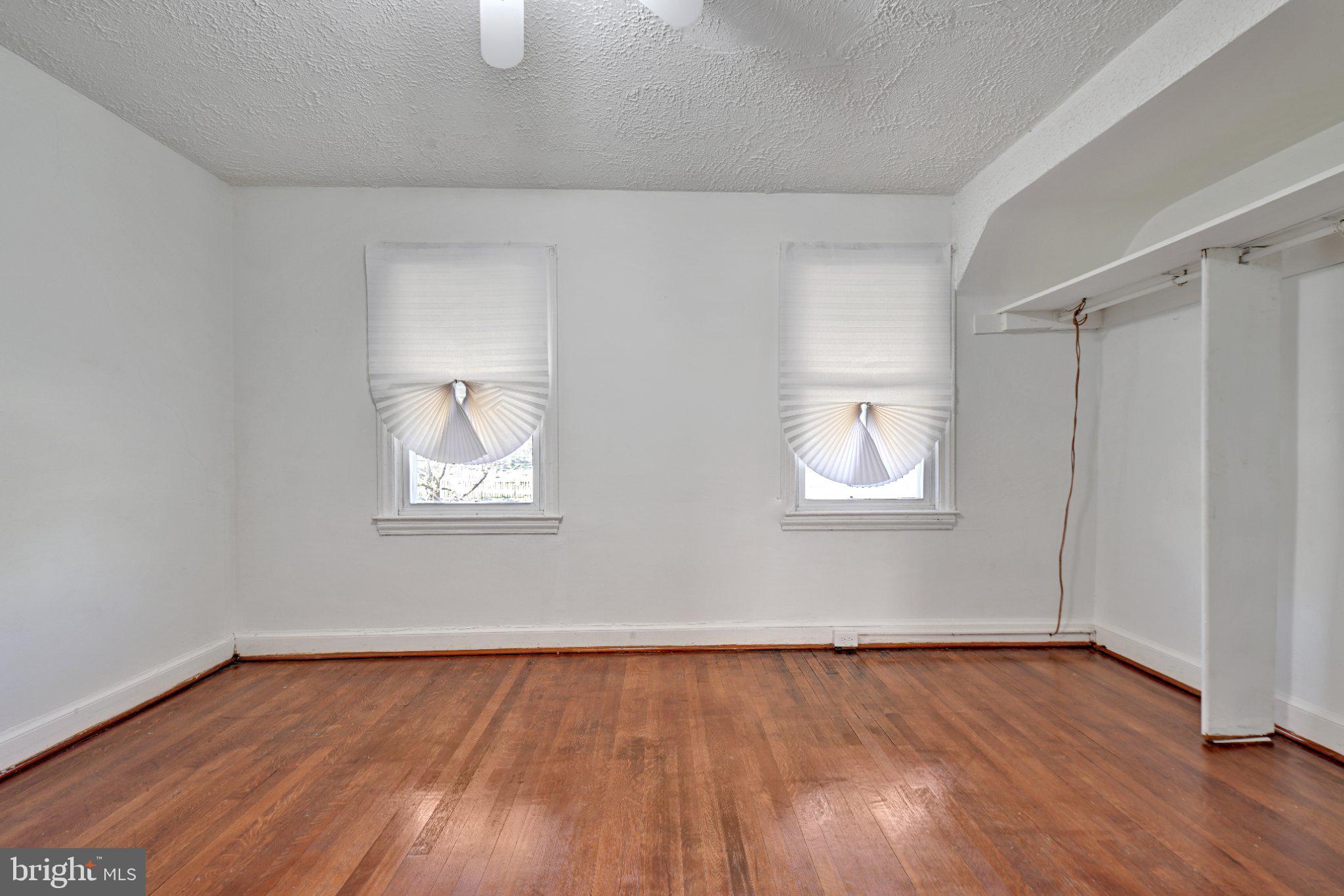 4607 North Capitol Street Northeast Washington, DC 20011 - Photo 10 of 25 an empty room with wooden floor and windows