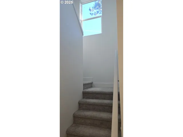 a view of staircase with white walls