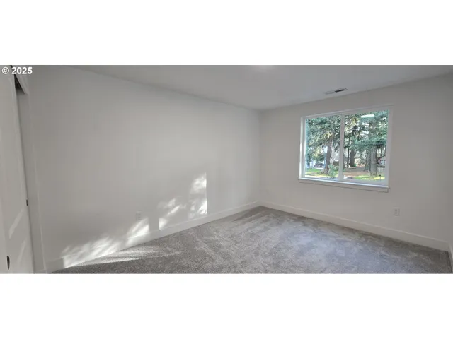a view of an empty room with windows