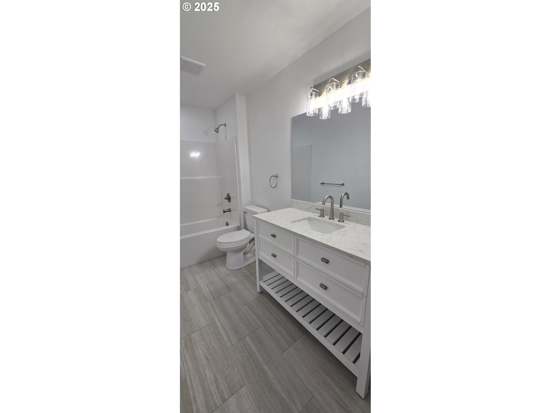 12451 Southeast Harold Street, Unit 1 Portland, OR 97236 - Photo 21 of 21 a bathroom with a double vanity sink and a mirror