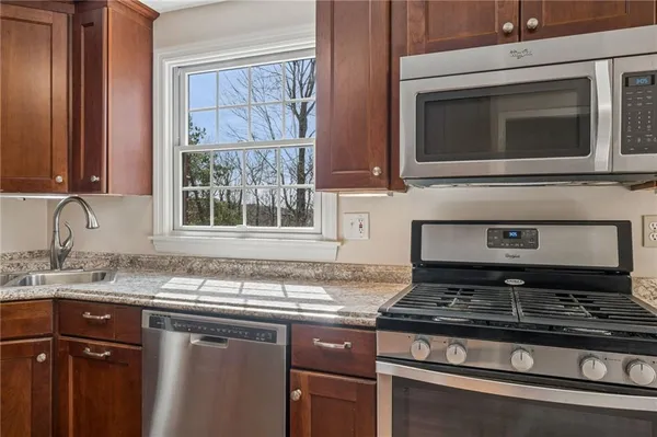 a kitchen with granite countertop a stove and a sink