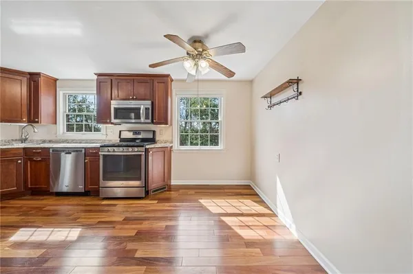 a kitchen with stainless steel appliances a stove a sink and a refrigerator
