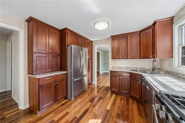 a kitchen with stainless steel appliances granite countertop a refrigerator stove and sink