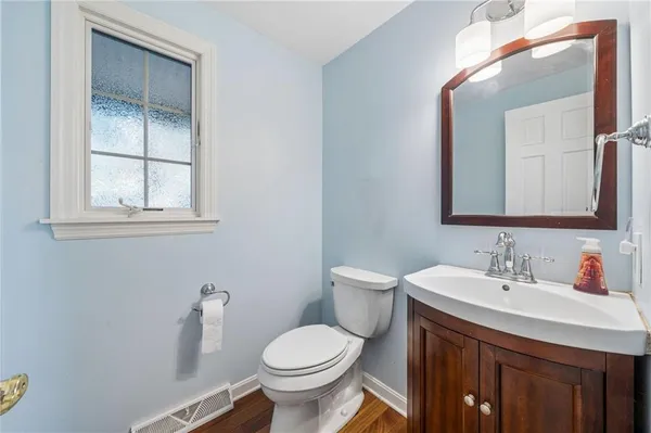 a bathroom with a toilet sink and mirror