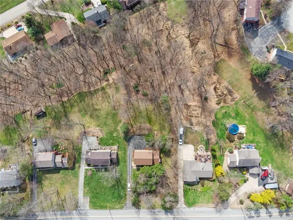 a aerial view of a houses with yard