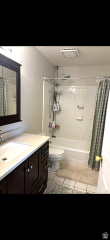 1324 West Raintree Drive, Unit 44 Price, UT 84501 - Photo 16 of 25 Bathroom featuring a dark wood-finish vanity with a light-colored countertop, an undermount sink, and a mirrored medicine cabinet