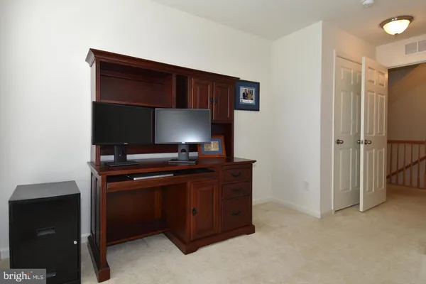 a room with a desk and a painting