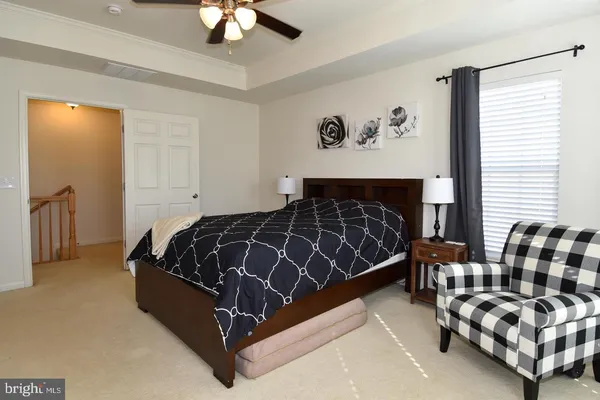 a bedroom with bed lamp and window