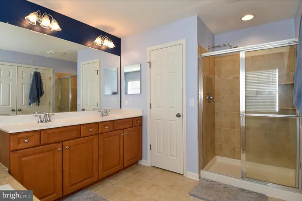 a spacious bathroom with a double vanity sink and a mirror