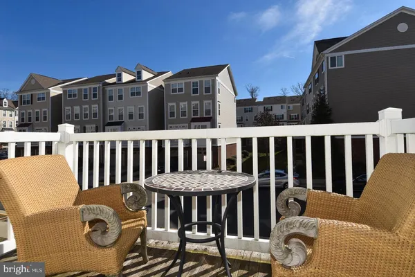 a view of a chair and a table and chairs on the roof deck