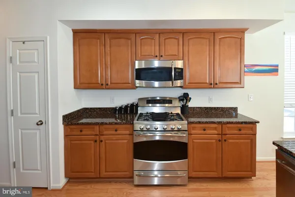 a kitchen with stainless steel appliances granite countertop a stove and a sink