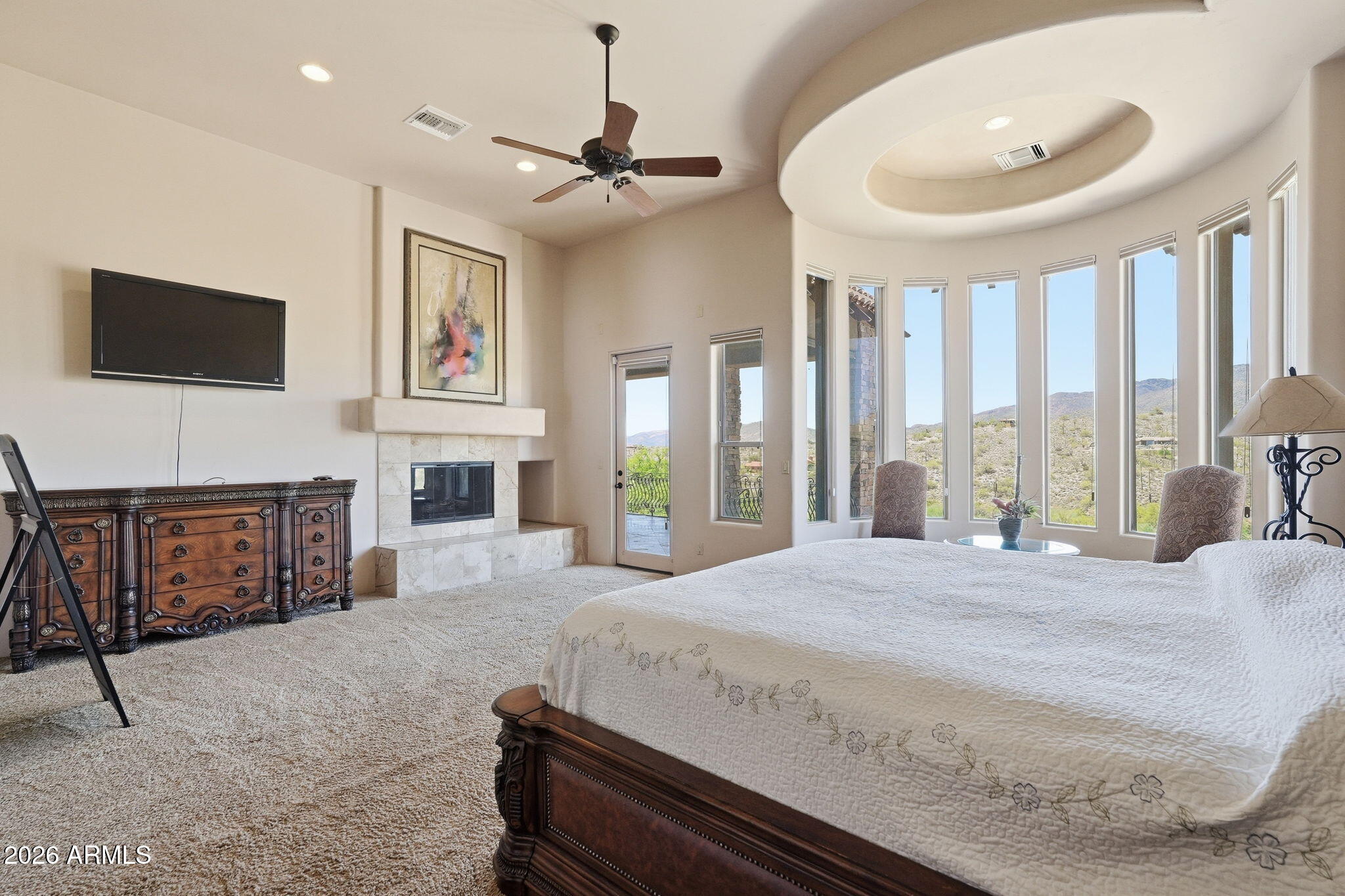 38211 North Sombrero Road Carefree, AZ 85377 - Photo 19 of 50 a spacious bedroom with a bed and a fireplace