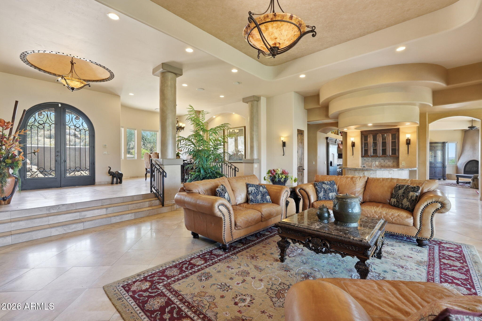38211 North Sombrero Road Carefree, AZ 85377 - Photo 3 of 50 a living room with furniture a chandelier and a rug