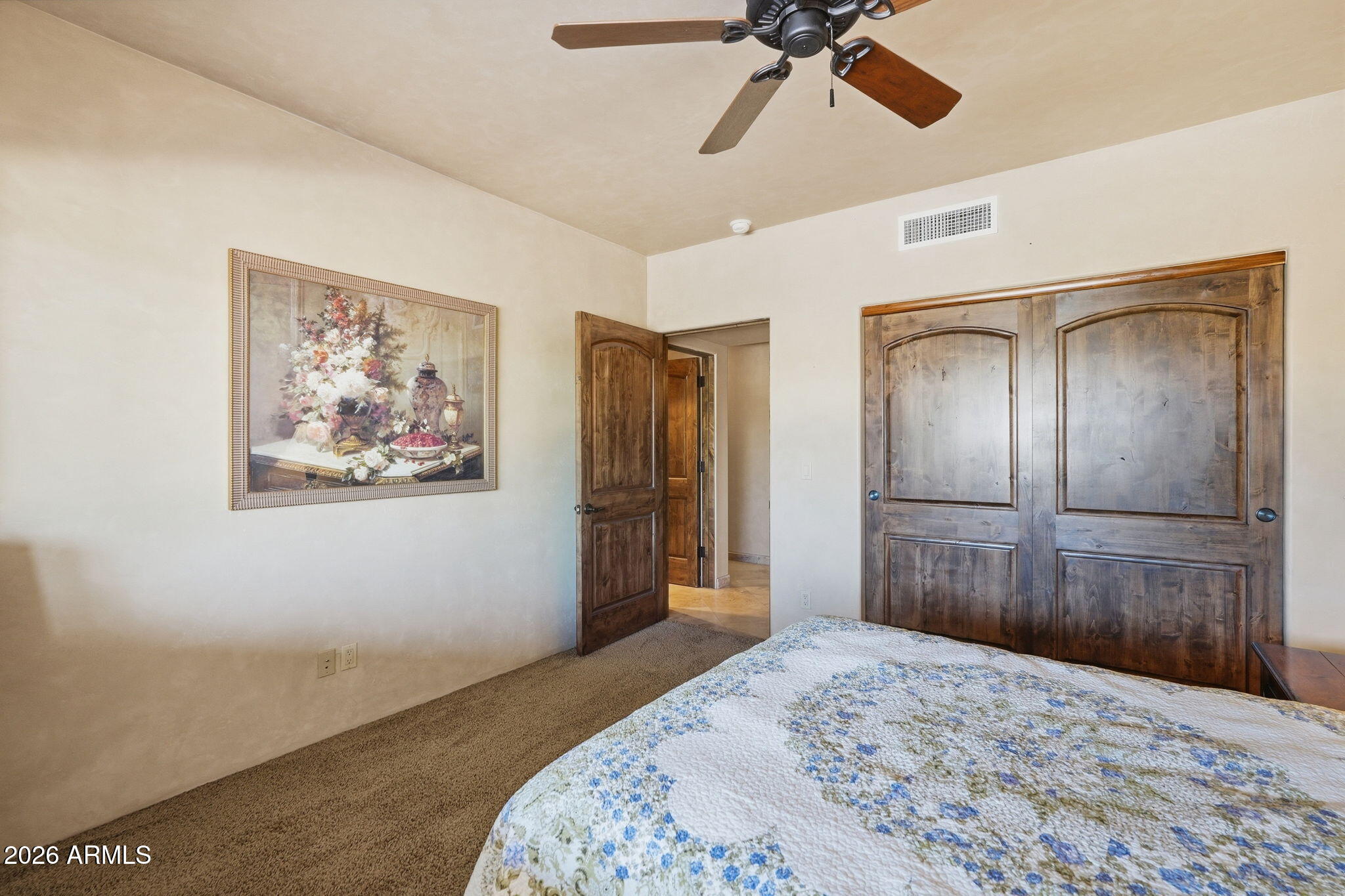 38211 North Sombrero Road Carefree, AZ 85377 - Photo 36 of 50 a bedroom with a bed and a chandelier