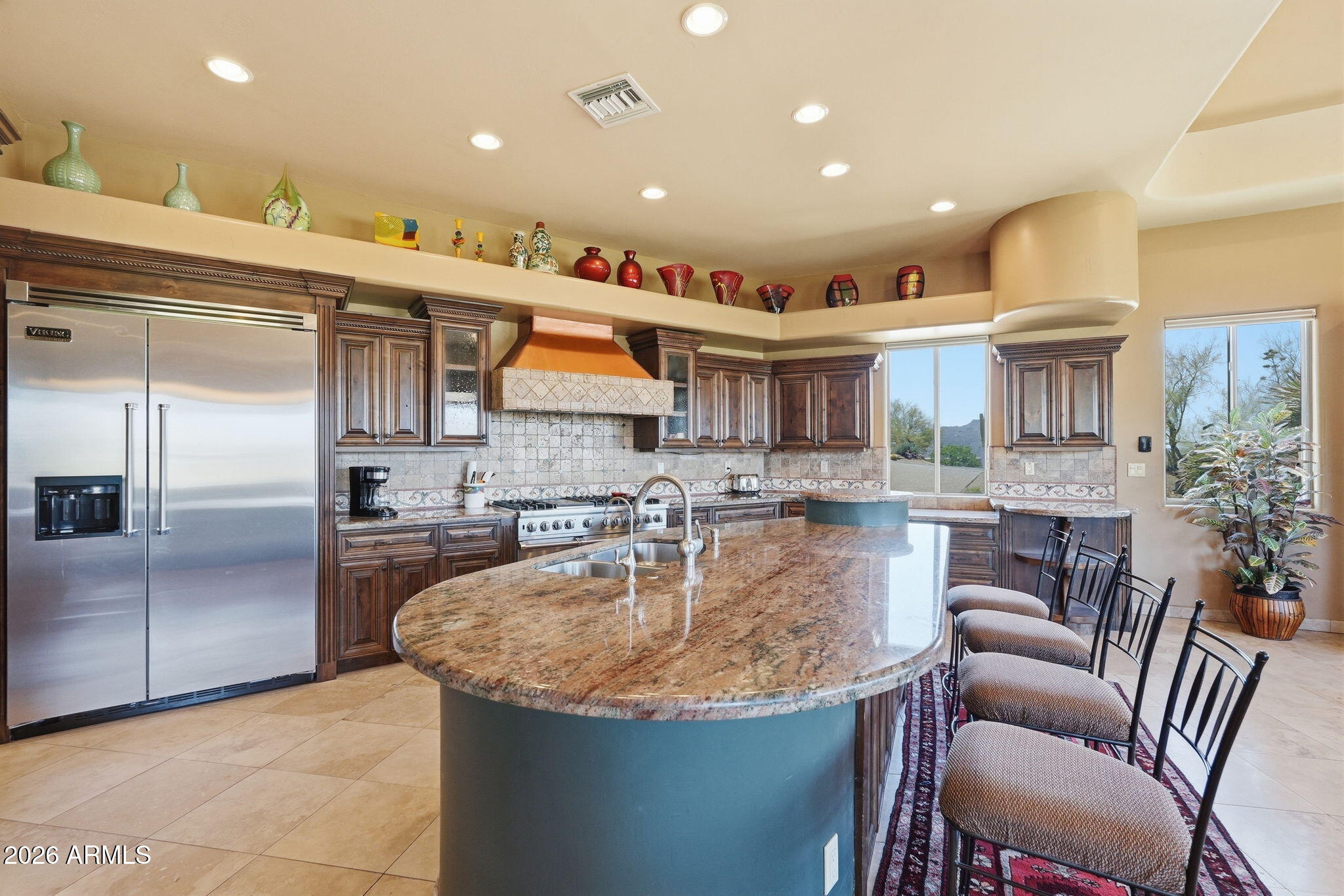 38211 North Sombrero Road Carefree, AZ 85377 - Photo 9 of 50 a kitchen with stainless steel appliances granite countertop a sink and a refrigerator