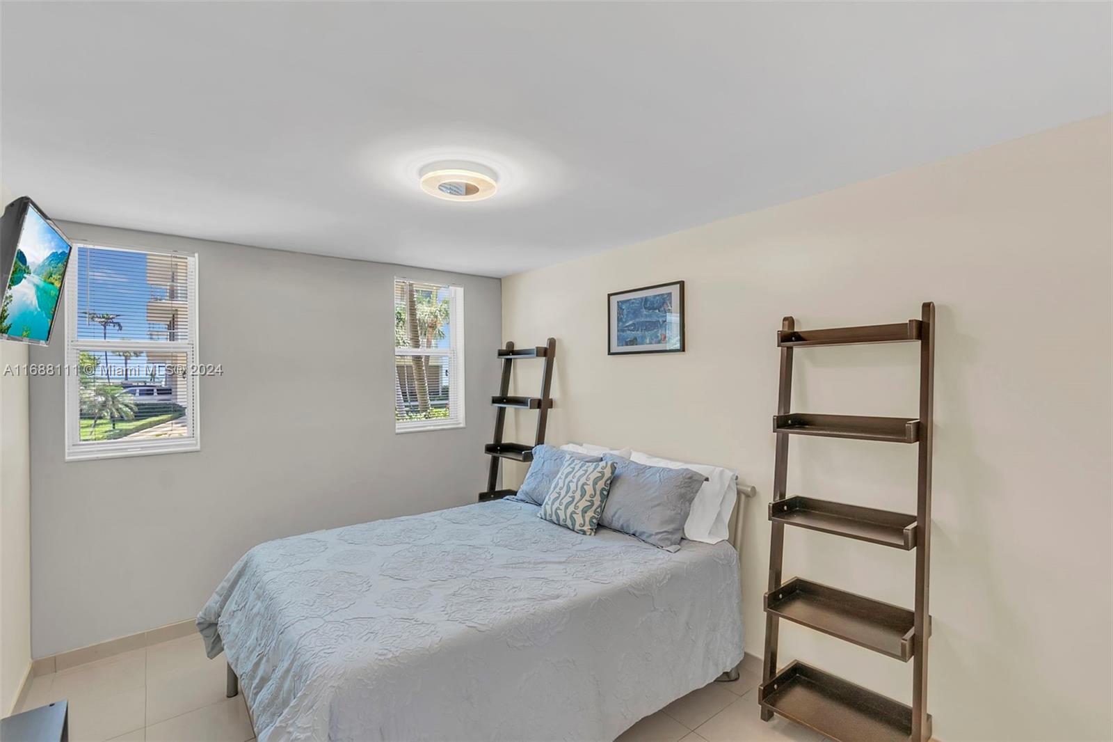 8888 Collins Avenue, Unit 113 Surfside, FL 33154 - Photo 11 of 14 a bedroom with a bed and a window