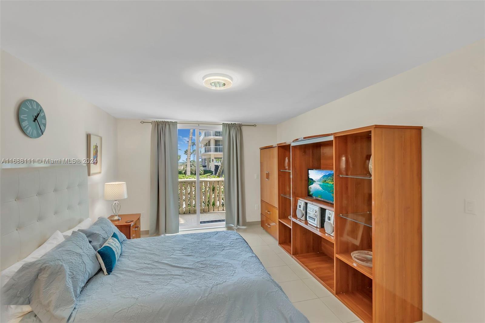 8888 Collins Avenue, Unit 113 Surfside, FL 33154 - Photo 12 of 14 a bed room with a bed and a large window