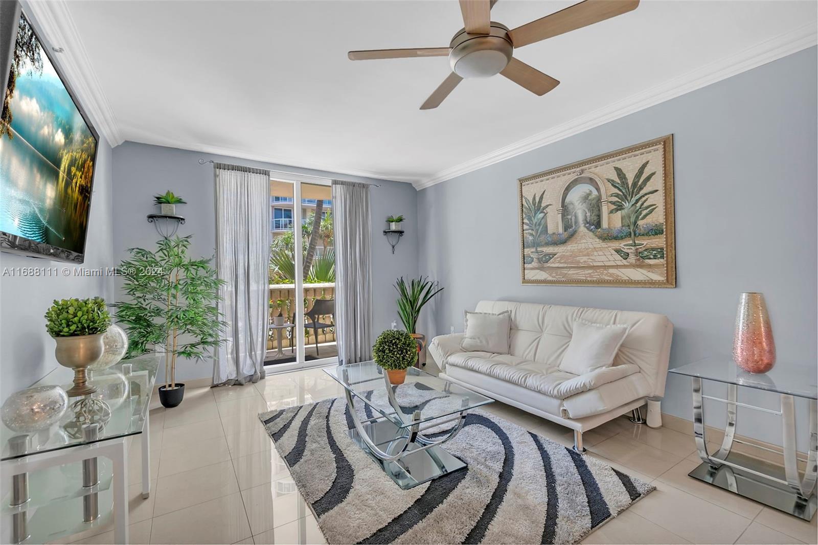 8888 Collins Avenue, Unit 113 Surfside, FL 33154 - Photo 5 of 14 a living room with furniture and a potted plant