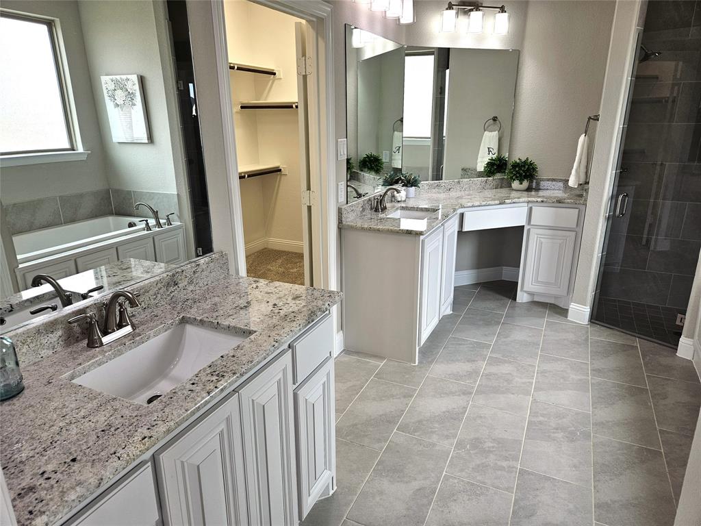 241 Blythe Road Van Alstyne, TX 75495 - Photo 18 of 37 a bathroom with a granite countertop sink a mirror and a bathtub
