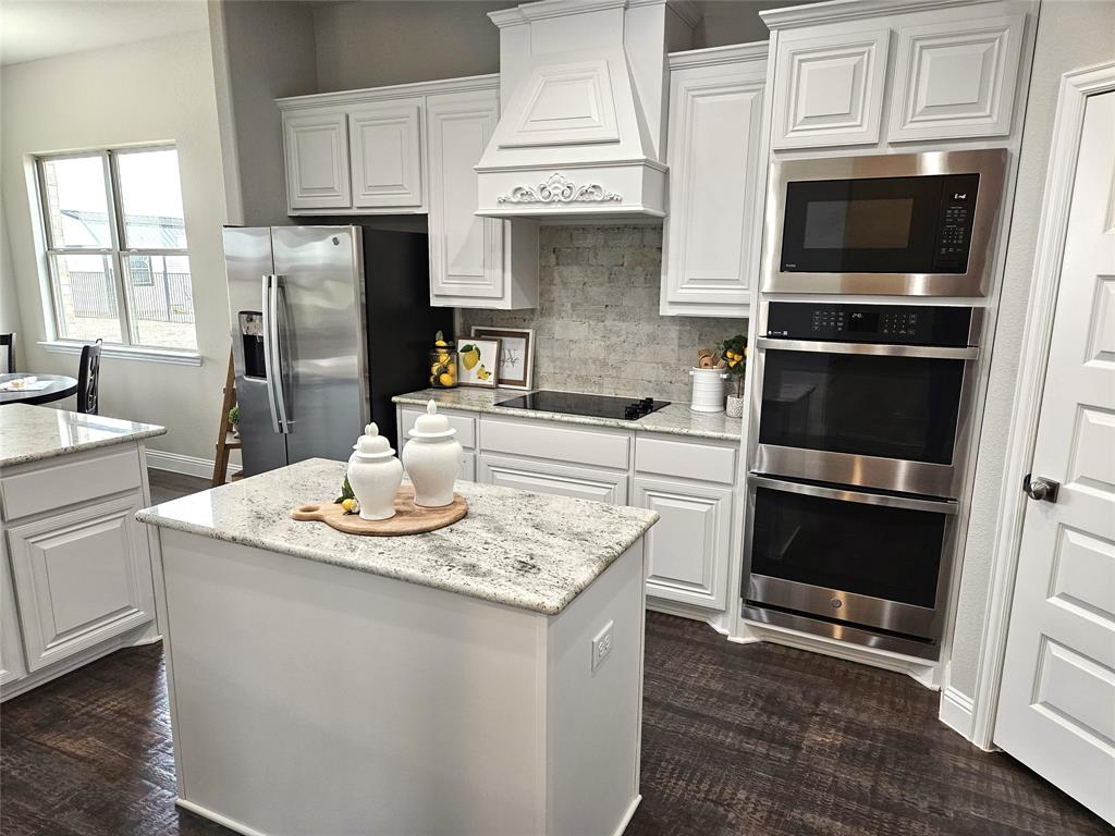 241 Blythe Road Van Alstyne, TX 75495 - Photo 2 of 37 a kitchen with stainless steel appliances a stove microwave and refrigerator