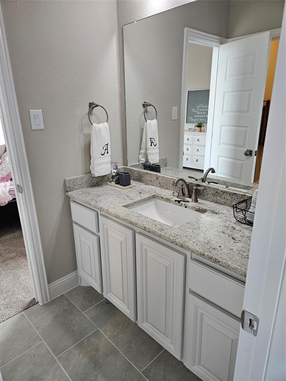 241 Blythe Road Van Alstyne, TX 75495 - Photo 31 of 37 a bathroom with a granite countertop sink and a mirror