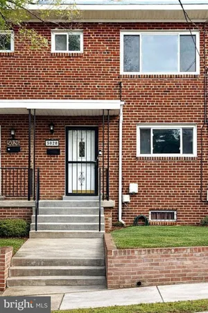 a view of a brick house with large windows