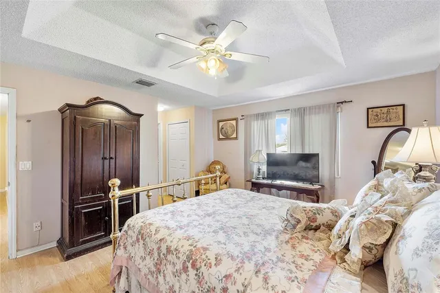 a bedroom with a bed and a chandelier