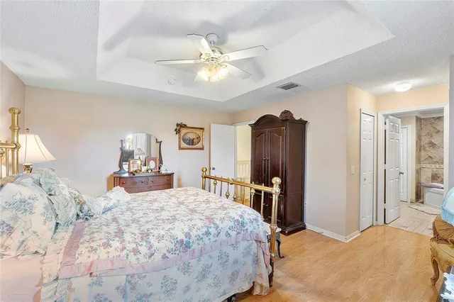 a bedroom with a bed and a chandelier