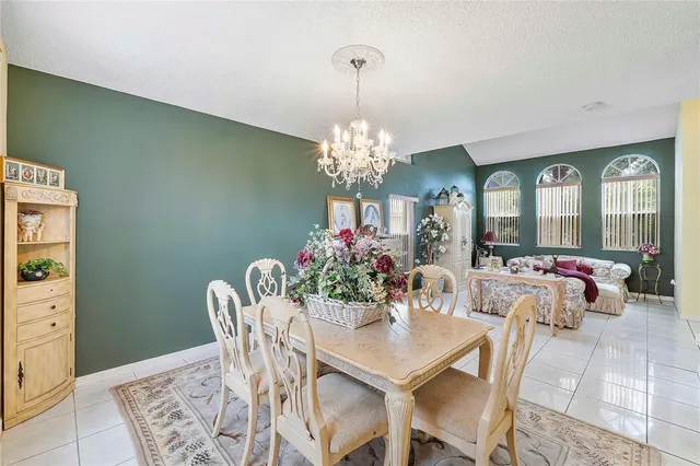 a view of a dining room with furniture and chandelier