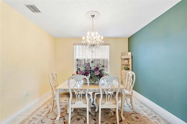 a view of a dining room with furniture and chandelier