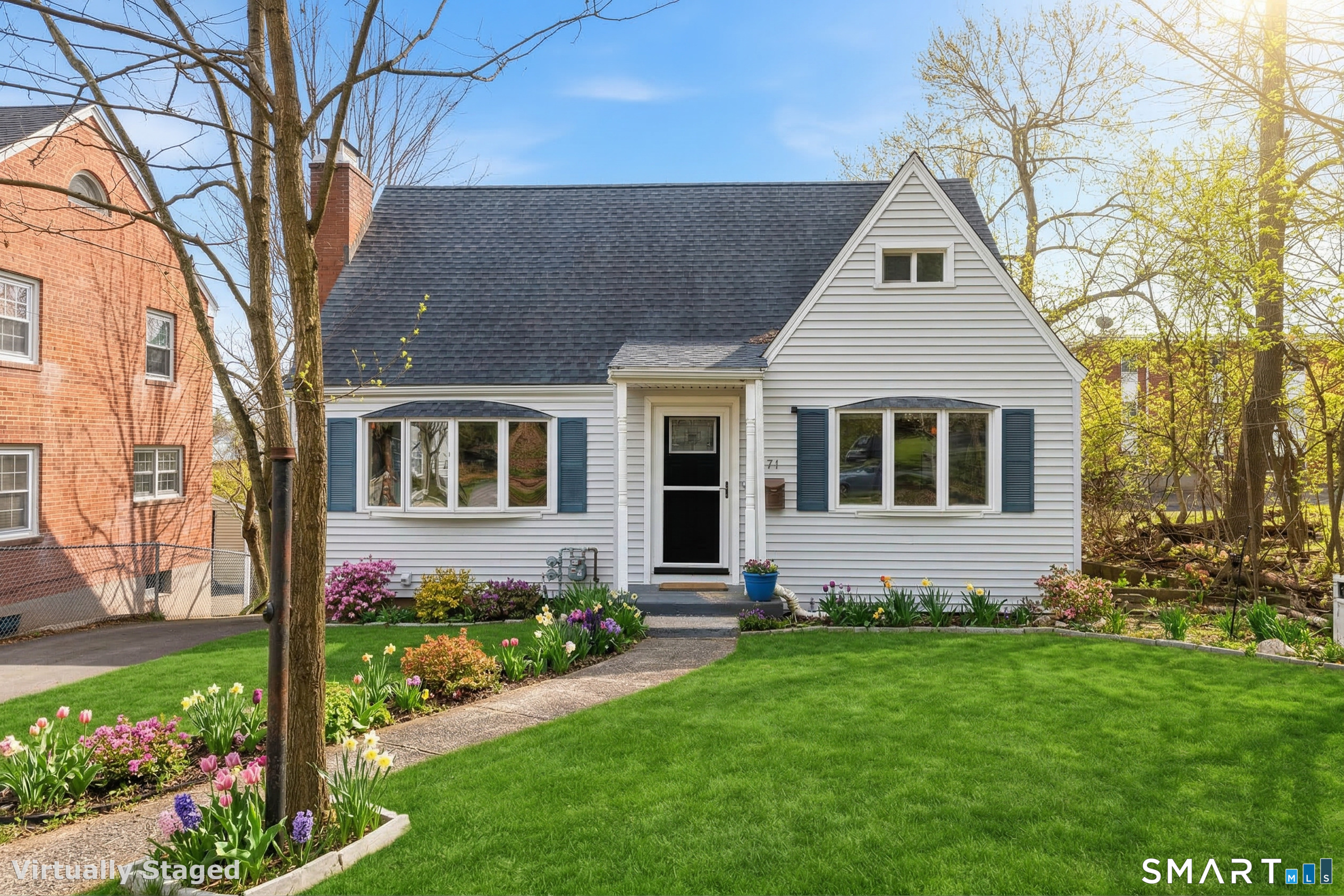 a front view of a house with a garden
