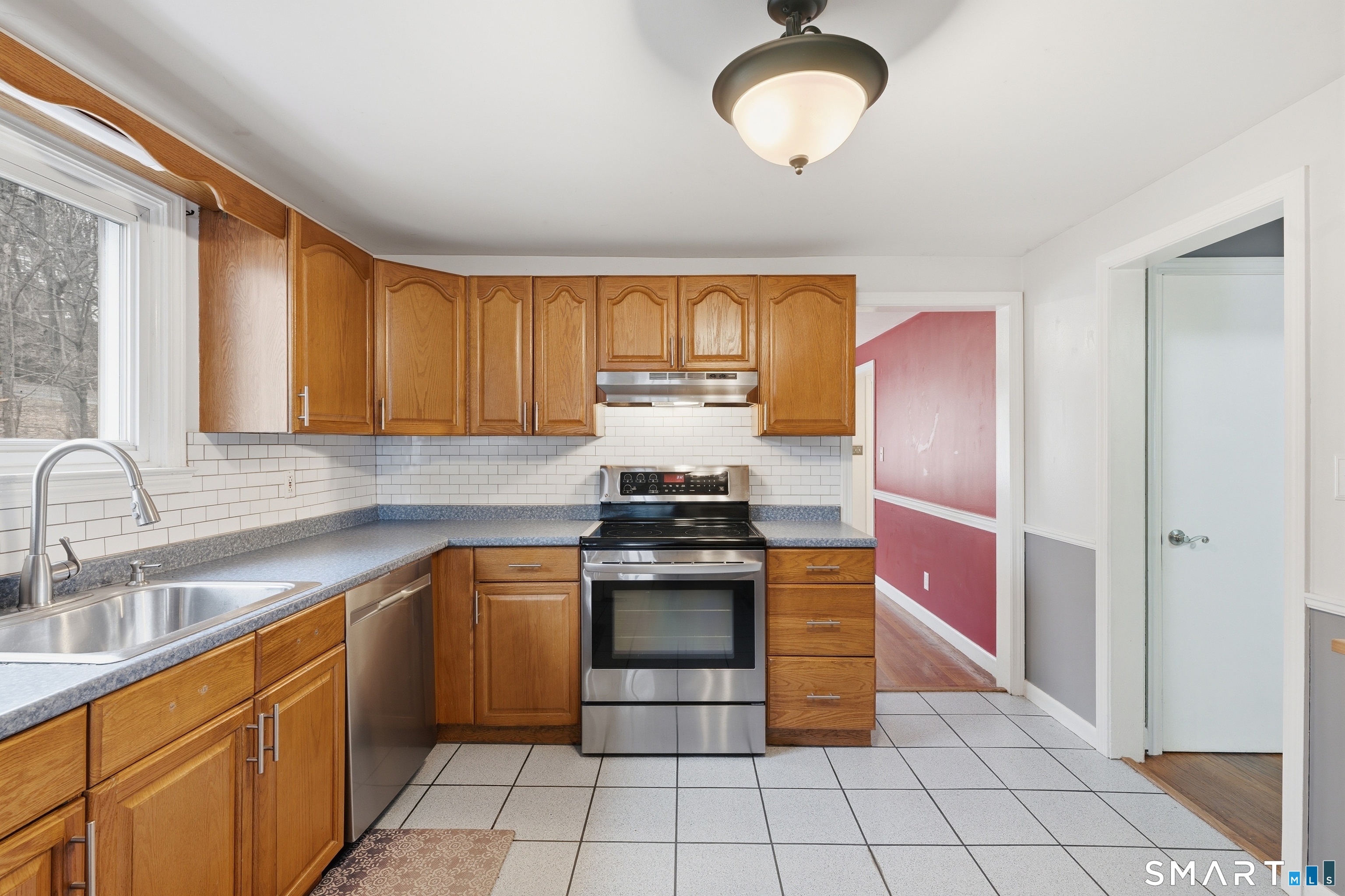 71 Hatch Street New Britain, CT 06053 - Photo 11 of 34 a kitchen with stainless steel appliances granite countertop a stove sink and cabinets