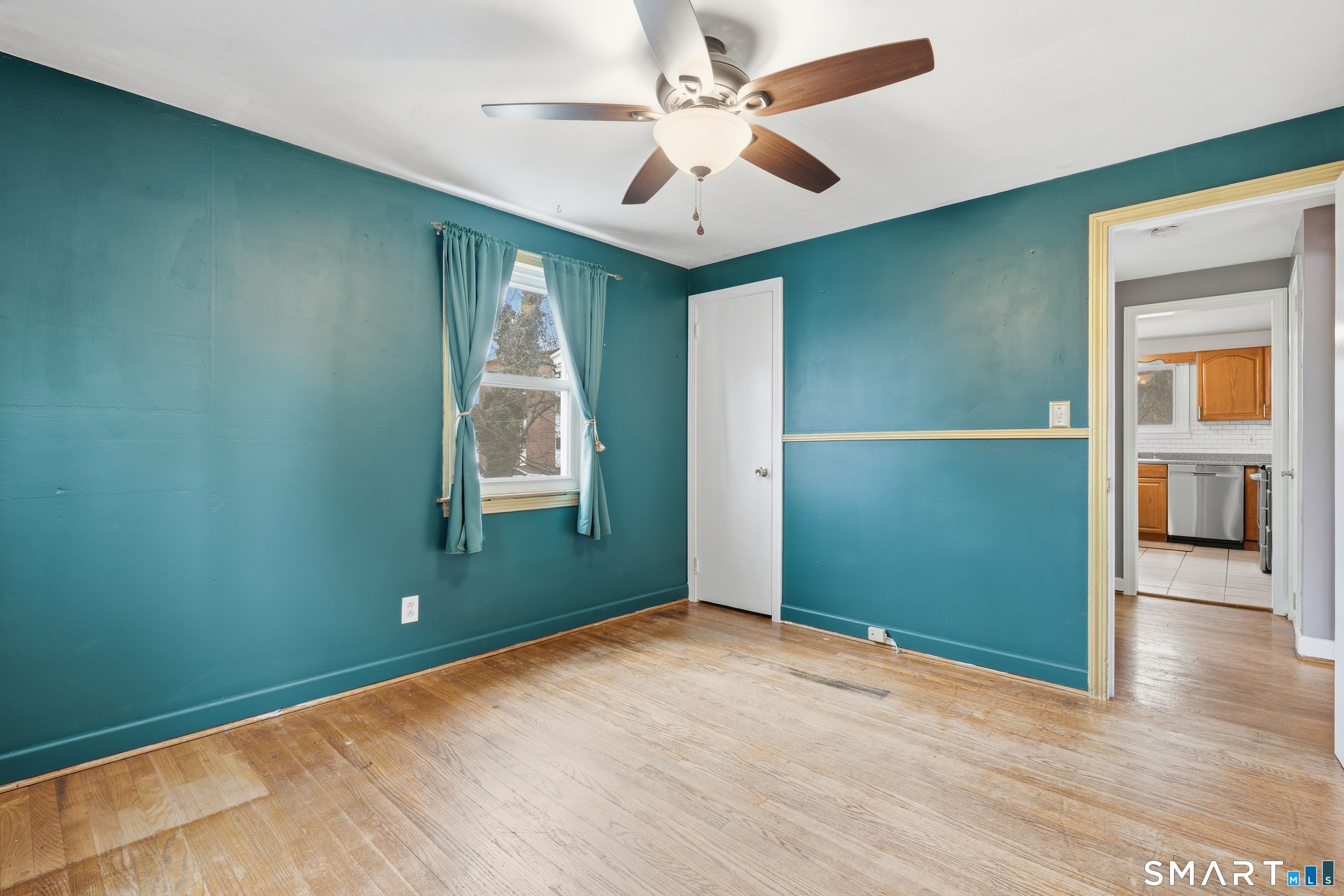 71 Hatch Street New Britain, CT 06053 - Photo 13 of 34 an empty room with wooden floor fan and windows