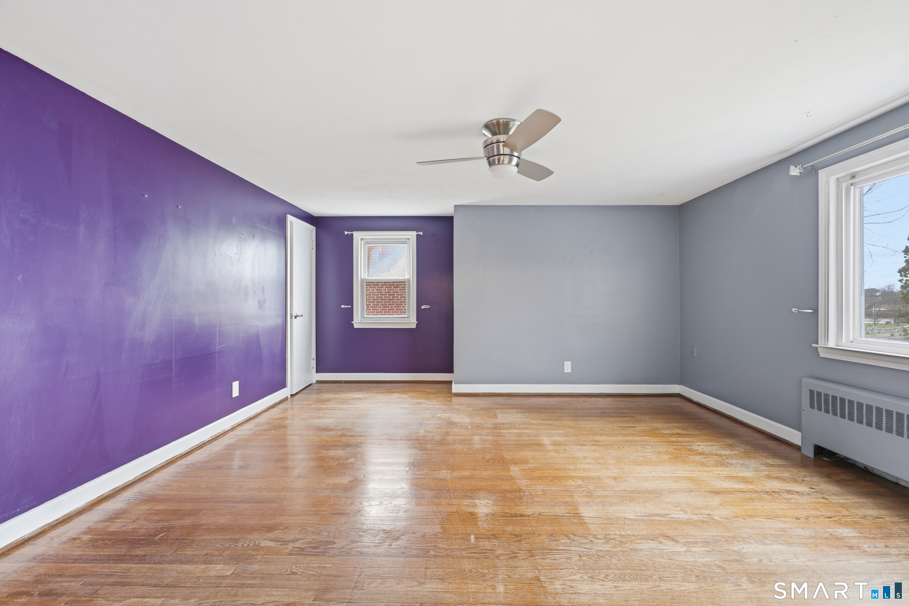 71 Hatch Street New Britain, CT 06053 - Photo 19 of 34 a view of empty room with wooden floor and fan
