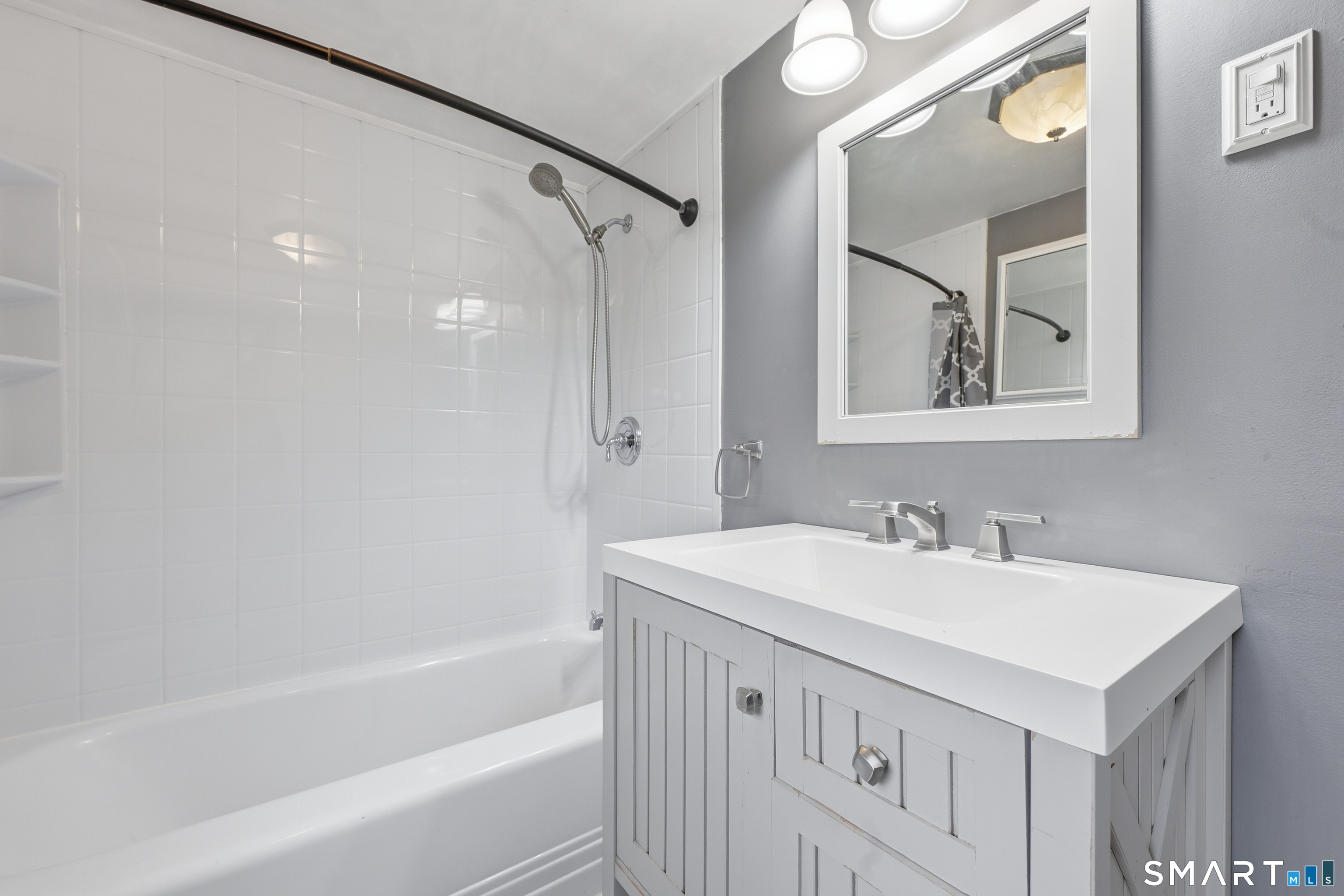 71 Hatch Street New Britain, CT 06053 - Photo 26 of 34 a bathroom with a sink vanity tub shower and a mirror