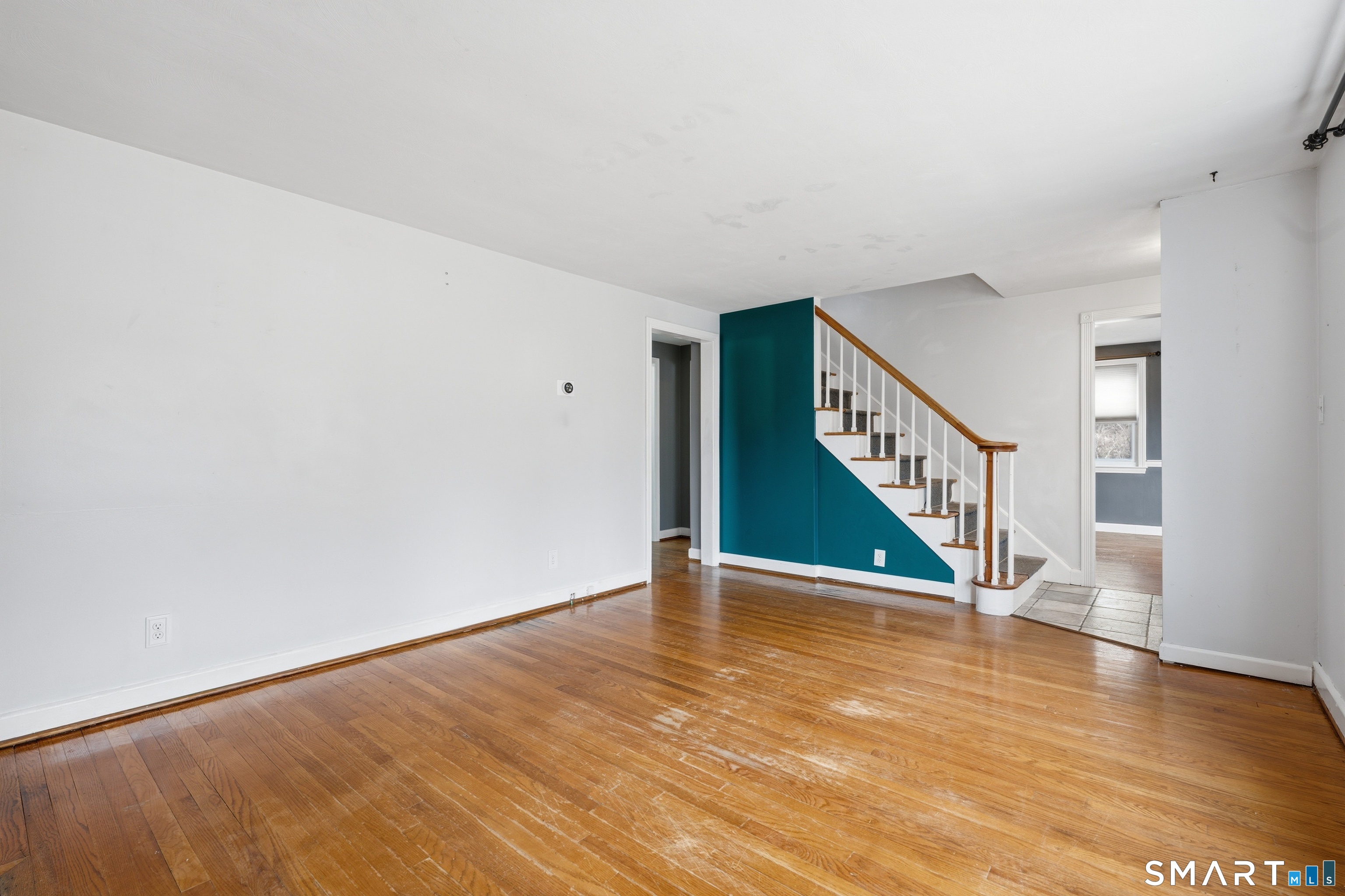 71 Hatch Street New Britain, CT 06053 - Photo 5 of 34 a view of an empty room with wooden floor