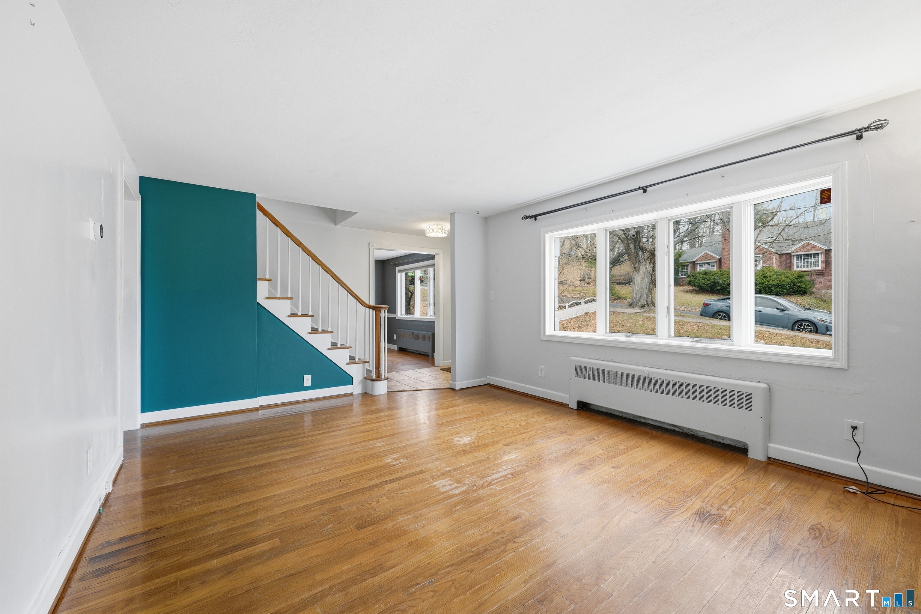71 Hatch Street New Britain, CT 06053 - Photo 6 of 34 a view of an empty room with wooden floor and a window
