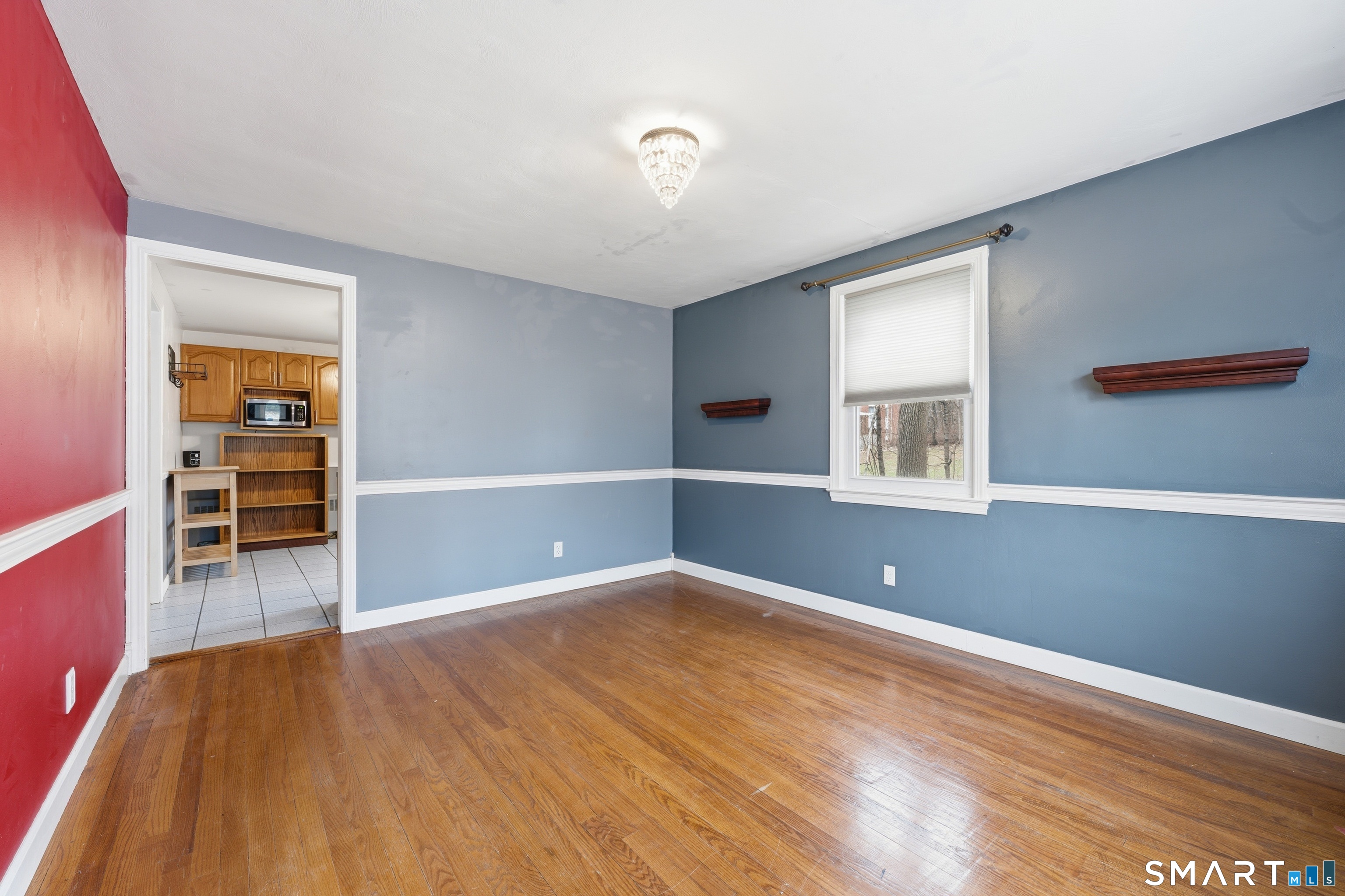 71 Hatch Street New Britain, CT 06053 - Photo 8 of 34 a view of empty room with wooden floor and fan