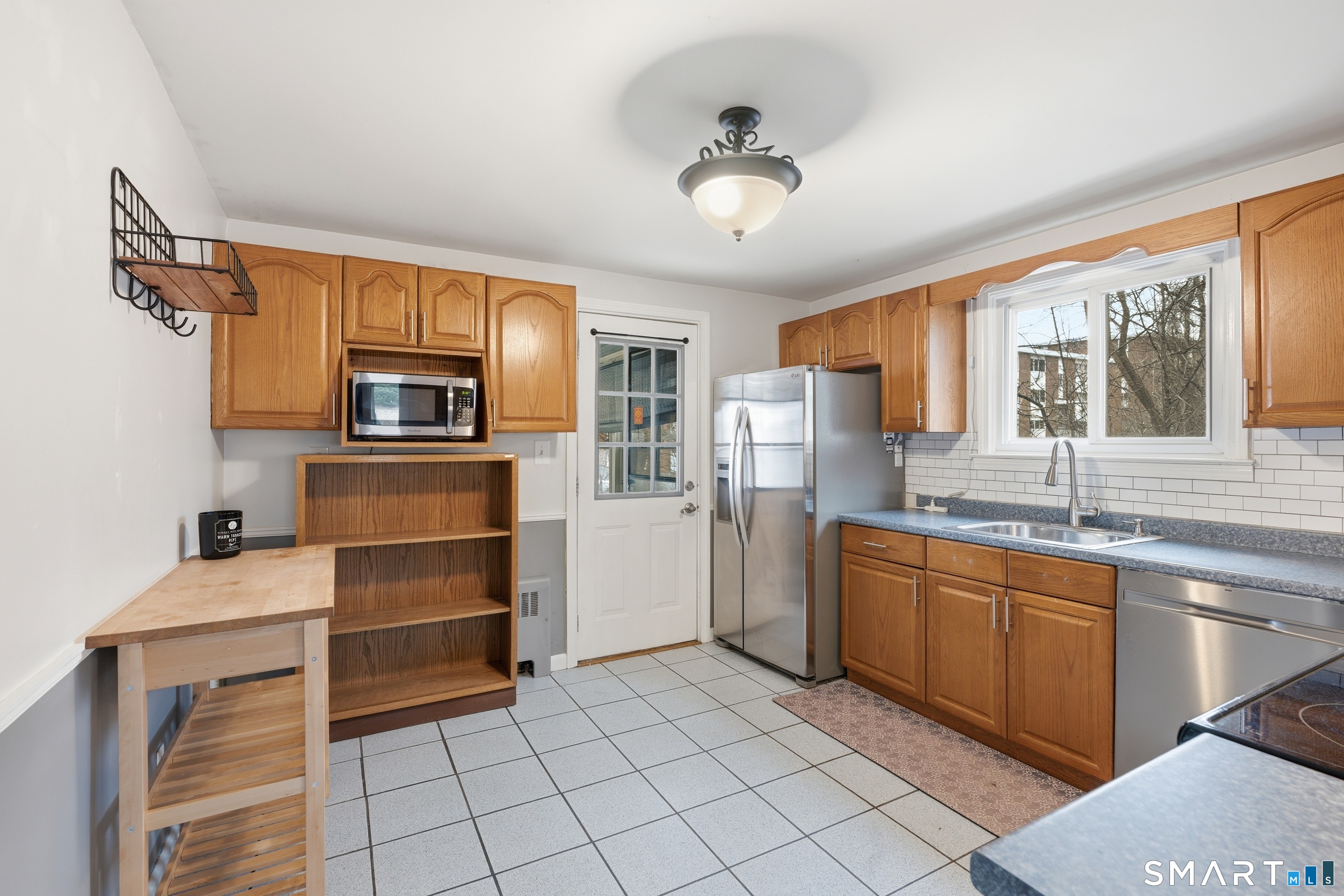 71 Hatch Street New Britain, CT 06053 - Photo 10 of 34 a kitchen with stainless steel appliances a stove sink and microwave