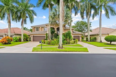 a view of house with swimming pool and green space
