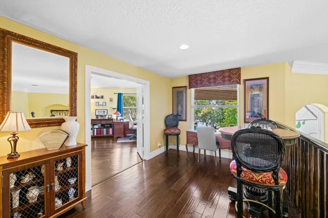 a view of a patio with couches table and chairs potted plants and a table and chair