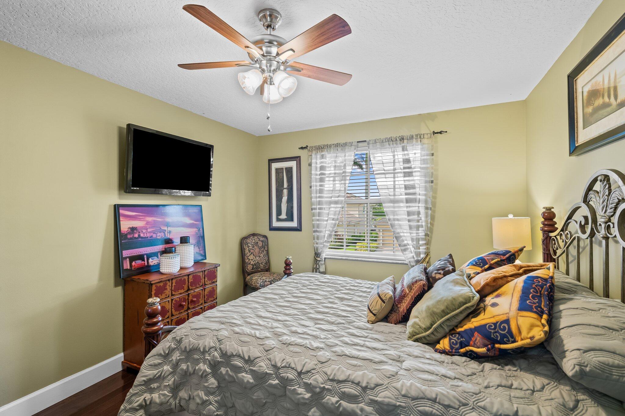 21167 Falls Ridge Way Boca Raton, FL 33428 - Photo 36 of 72 a bedroom with a bed and a flat screen tv