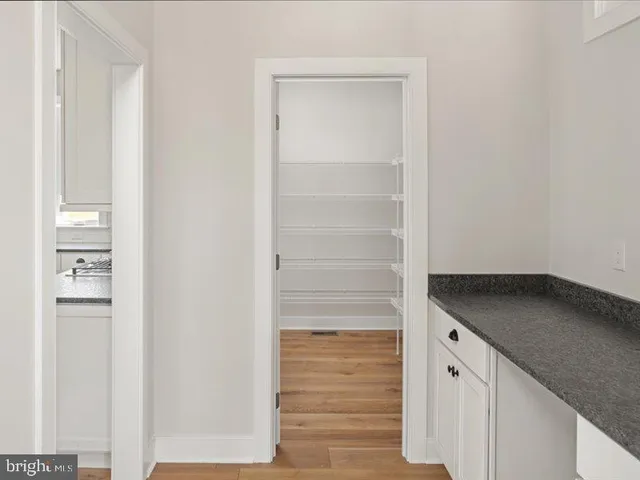 a kitchen with a sink window and cabinets